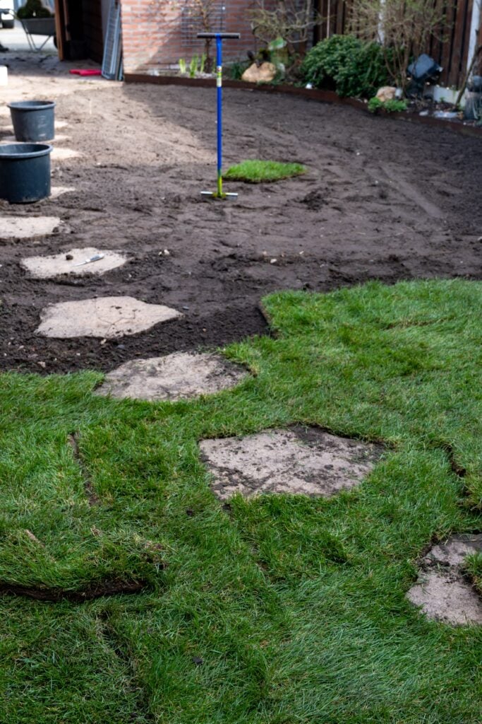 Spring garden renovation works with sods, professional laying of new turf rolls of real grass, fertilising and ploughing, preparation of perfect lawn of green grass