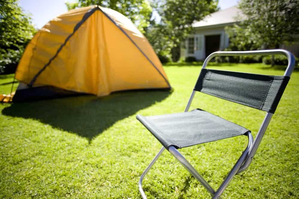 camping chair and tent in backyard