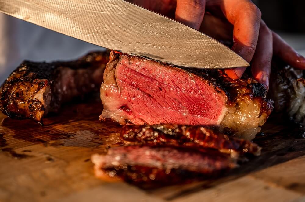 Carving some delicious steak fresh from the backyard BBQ.
