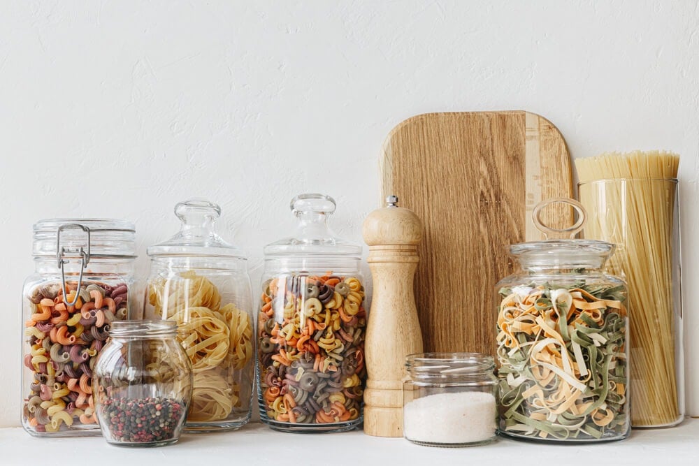 Storing various pasta and grains in sturdy glass jars.