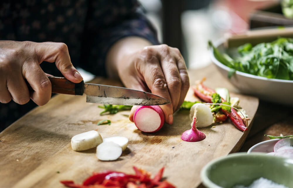 Carefully chopping some fresh turnips for an epic garden salad.