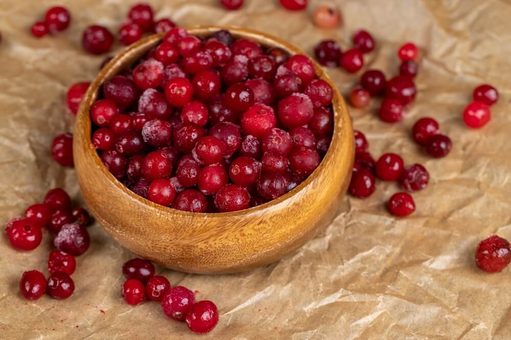 Delicious tart and red cranberries in a bowl.