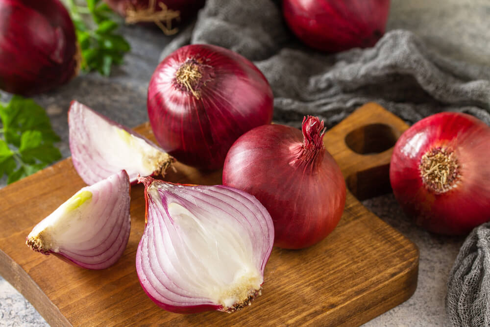 Freshly sliced purple onions on the countertop.