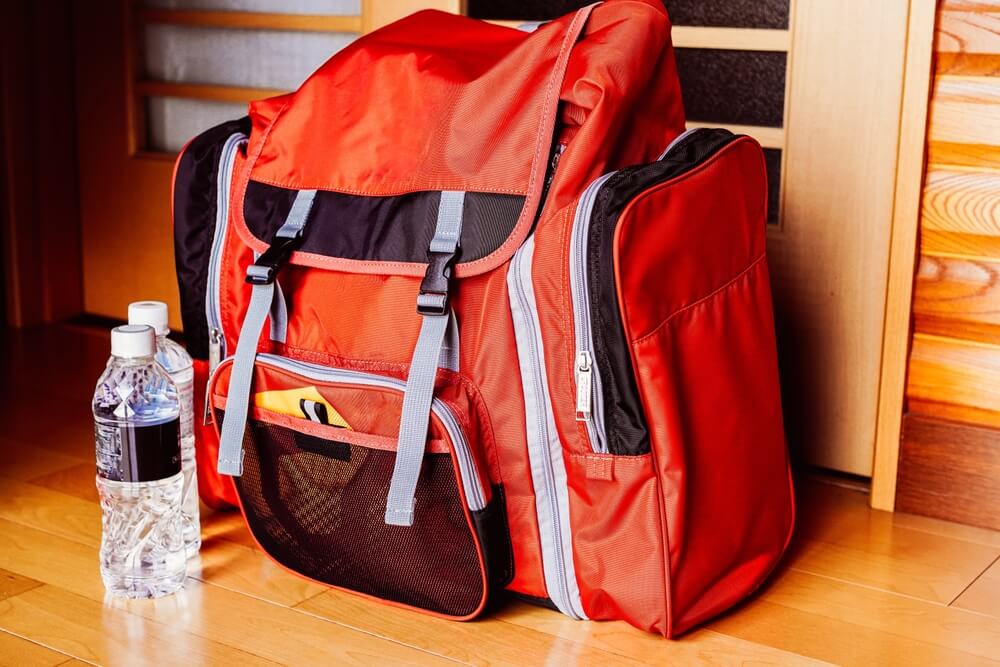 Emergency kit with preparedness supplies for earthquakes disasters or fires.