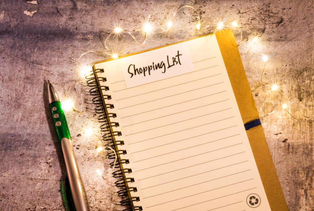 Shopping list notebook on a lovely table with fancy lights.