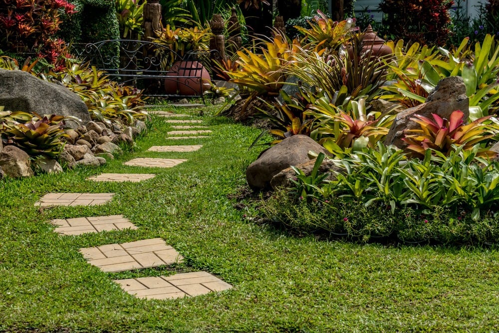 Beautiful garden landscape design in the park with fancy shrubs and path.