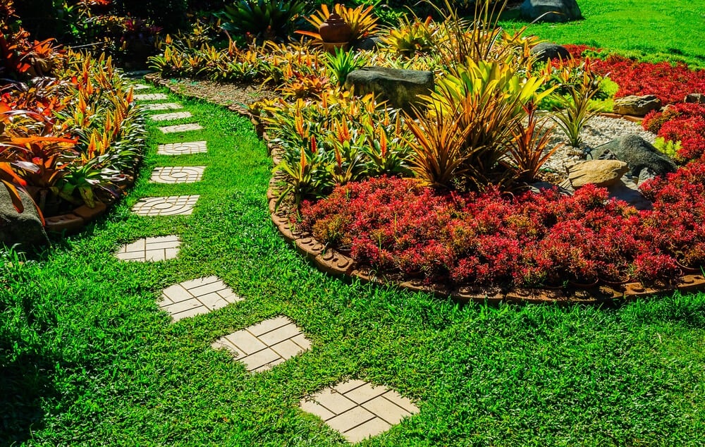 Gorgeous garden landscape design with fancy pathway and many shrubs.