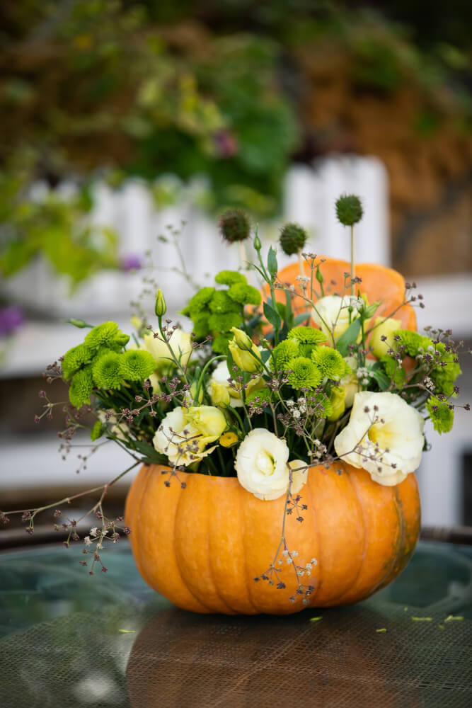 Beautiful pumpkin planter with gorgeous plants and flowers.