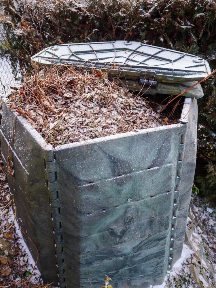 Plastic composter in winter, composting process restarts in spring.