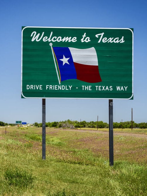 welcome to texas state sign reminding drivers to drive friendly