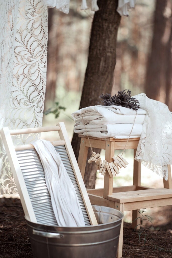 Retro wash on the village by the river. Bed linen is hung on a string and piled up. Dry lavender.